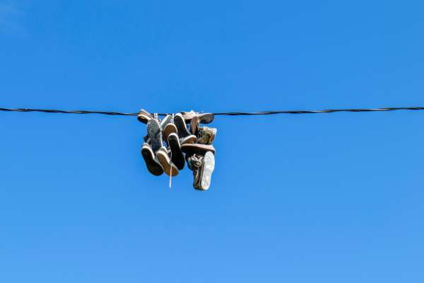 qué significan los tenis colgados en los cables de electricidad en las calles